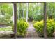 Tranquil backyard view from covered patio with stone pathway and wooded scenery at 2262 Silver Fox Ln, Buford, GA 30519