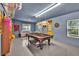 Recreation area in the basement with a pool table, large windows and comfortable seating at 2262 Silver Fox Ln, Buford, GA 30519