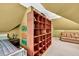 Attic bedroom featuring large shelving unit, carpet and a bed at 2262 Silver Fox Ln, Buford, GA 30519