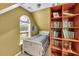 Attic bedroom featuring a bed, arched window and built in shelving at 2262 Silver Fox Ln, Buford, GA 30519