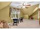 Attic bonus bedroom featuring a ceiling fan, and seating area with love seat at 2262 Silver Fox Ln, Buford, GA 30519