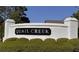 Welcoming 'Quail Creek' community sign with a classic white brick surround and manicured greenery at 2262 Silver Fox Ln, Buford, GA 30519