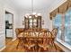 Formal dining room with wood floors, trim, and large wood table with seating for six at 2262 Silver Fox Ln, Buford, GA 30519