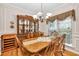 Formal dining room with wood floors, trim, and large wood table with seating for six at 2262 Silver Fox Ln, Buford, GA 30519