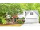 Charming two-story home with white siding, brick accents, attached garage, and mature landscaping at 2262 Silver Fox Ln, Buford, GA 30519
