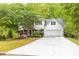 Charming two-story home with white siding, brick accents, attached garage, and long driveway at 2262 Silver Fox Ln, Buford, GA 30519