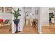 Inviting hallway with hardwood floors, neutral paint, stylish decor, and views into the kitchen at 2262 Silver Fox Ln, Buford, GA 30519