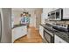 Kitchen view featuring granite countertops, white cabinets and stainless steel appliances overlooking dining space at 2262 Silver Fox Ln, Buford, GA 30519