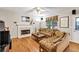 Living room with fireplace, hardwood floors, comfortable seating, and natural light at 2262 Silver Fox Ln, Buford, GA 30519