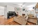 Spacious living room with fireplace, hardwood floors, TV, and comfortable seating at 2262 Silver Fox Ln, Buford, GA 30519