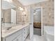 Bathroom with double sink vanity, soaking tub, and doorway to main bedroom at 2262 Silver Fox Ln, Buford, GA 30519