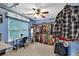 Spacious walk-in closet with blue walls, desk with lots of clothing and a ceiling fan at 2262 Silver Fox Ln, Buford, GA 30519