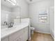 Bathroom features a vanity with sink, toilet, a tub and shower combination, and a window at 603 Spring Heights Se Ln # 6, Smyrna, GA 30080