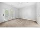 Bright bedroom features neutral carpeting, a ceiling fan, and access to a private balcony at 603 Spring Heights Se Ln # 6, Smyrna, GA 30080