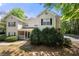 Charming townhome with manicured bushes and a welcoming front porch entrance and traditional black window shutters at 603 Spring Heights Se Ln # 6, Smyrna, GA 30080