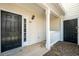 Inviting front entrance featuring a covered porch and black front door with sidelight window, offering a warm welcome at 603 Spring Heights Se Ln # 6, Smyrna, GA 30080