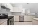 Spacious kitchen with stainless steel appliances, white cabinetry, and tile flooring, ideal for cooking and entertaining at 603 Spring Heights Se Ln # 6, Smyrna, GA 30080