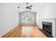 Bright living room with hardwood floors, a fireplace, and large windows, creating a cozy and inviting atmosphere at 603 Spring Heights Se Ln # 6, Smyrna, GA 30080
