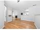 Open-concept living room with hardwood floors, a fireplace, and seamless flow into the adjacent kitchen at 603 Spring Heights Se Ln # 6, Smyrna, GA 30080