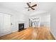 Cozy living room featuring hardwood floors, a fireplace, and access to the kitchen, perfect for entertaining at 603 Spring Heights Se Ln # 6, Smyrna, GA 30080