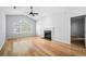 Bright living room with vaulted ceilings, a fireplace, and hardwood floors, creating a comfortable and stylish living space at 603 Spring Heights Se Ln # 6, Smyrna, GA 30080