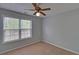 Bright and airy bedroom has a ceiling fan and large window at 1080 Smoke Hill Ln, Hoschton, GA 30548