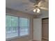 This bedroom has neutral walls and carpet and a window with a view to the outside at 1080 Smoke Hill Ln, Hoschton, GA 30548