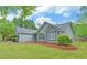 Charming home exterior with well-manicured landscaping and a well maintained lawn and trees at 1080 Smoke Hill Ln, Hoschton, GA 30548
