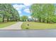 Well-maintained home with a long driveway and mature trees, set back from the road at 1080 Smoke Hill Ln, Hoschton, GA 30548