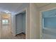 Hallway view to the main living space and bedroom featuring wood-look floors at 1080 Smoke Hill Ln, Hoschton, GA 30548