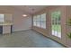 Bright kitchen features two-tone cabinets, modern appliances, and access to the backyard at 1080 Smoke Hill Ln, Hoschton, GA 30548