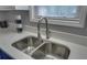 The kitchen features a double sink with a modern faucet and a window with natural light at 1080 Smoke Hill Ln, Hoschton, GA 30548