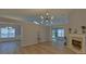 Bright living room features an elegant fireplace, and seamless flooring at 1080 Smoke Hill Ln, Hoschton, GA 30548
