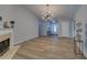 Spacious living room with fireplace, modern lighting, and neutral color palette at 1080 Smoke Hill Ln, Hoschton, GA 30548