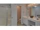 Well-lit main bathroom has a glass shower, vanity with sink, and neutral paint at 1080 Smoke Hill Ln, Hoschton, GA 30548