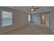 The main bedroom features plush carpet, and large windows that let in ample natural light at 1080 Smoke Hill Ln, Hoschton, GA 30548