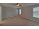 Spacious main bedroom with two windows and a ceiling fan at 1080 Smoke Hill Ln, Hoschton, GA 30548