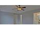 Spacious bedroom boasts a tray ceiling with fan, neutral paint, and access to a luxurious ensuite bathroom at 1080 Smoke Hill Ln, Hoschton, GA 30548