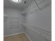 Spacious walk-in closet has an abundance of adjustable shelving to maximize storage and organization at 1080 Smoke Hill Ln, Hoschton, GA 30548
