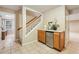 Finished basement area with wet bar, mini fridge, tiled floors, and stairway to the upper level at 5605 Preserve Cir, Johns Creek, GA 30005