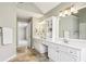 Elegant bathroom features double vanity, large mirrors and gorgeous tile at 5605 Preserve Cir, Johns Creek, GA 30005