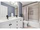 Updated bathroom with double vanity, modern fixtures, and tiled shower-tub at 5605 Preserve Cir, Johns Creek, GA 30005