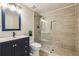 Modern bathroom featuring a glass-enclosed shower with niche, dark blue vanity, and modern fixtures at 5605 Preserve Cir, Johns Creek, GA 30005