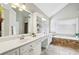 Elegant bathroom featuring double vanity, soaking tub and gorgeous tile at 5605 Preserve Cir, Johns Creek, GA 30005