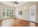 Light-filled bedroom with large windows and hardwood flooring, offering a cozy and bright space at 5605 Preserve Cir, Johns Creek, GA 30005