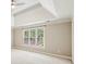 Spacious bedroom featuring tray ceiling, ceiling fan, and large window at 5605 Preserve Cir, Johns Creek, GA 30005
