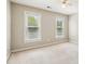 Bright, minimalist bedroom features neutral carpet and two large windows at 5605 Preserve Cir, Johns Creek, GA 30005