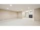 A spacious bonus room with tv, lighting, and a ceiling fan for entertainment and relaxation at 5605 Preserve Cir, Johns Creek, GA 30005