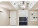 A bonus room with a large television and built in shelving with white trim and modern finishes at 5605 Preserve Cir, Johns Creek, GA 30005