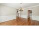 Formal dining room with hardwood floors, chandelier, and classic wainscoting, ideal for entertaining guests at 5605 Preserve Cir, Johns Creek, GA 30005